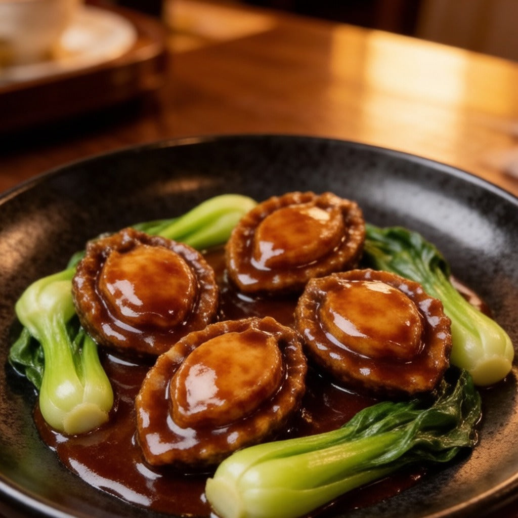 Braised abalone in glossy sauce with bok choy on a dark plate