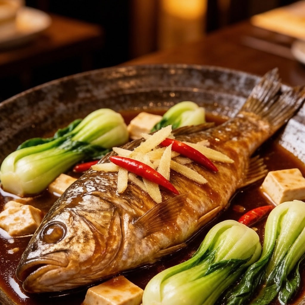 Whole braised sea bass with bok choy and tofu in a dark dish