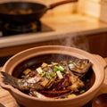 Whole grouper braised in a clay pot with spring onion and chilli